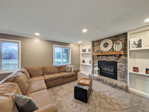 Cozy family room with a beautiful fireplace and built-ins for storage and display!