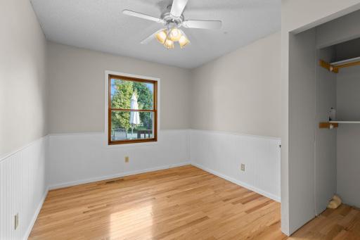 Main level bedroom featuring hardwood flooring. Beautiful mix of natural wood and white accents.
