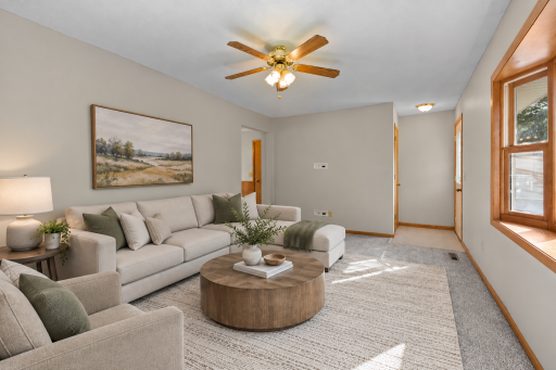 Relazed living room space wtih large bow window. This room virtually staged to help visualize the space and potential furniture layout.