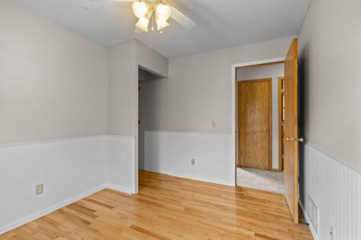 Main level bedroom with hardwood flooring.
