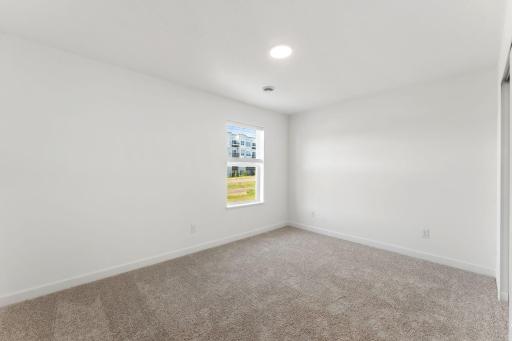The upper-level secondary bedrooms are perfectly situated away from the downstairs main living areas and are blank canvases ready to be personalized. Furnished here as a cozy nursery.