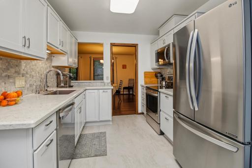 Kitchen opens to dining and also features a breakfast bar.