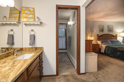 Entry to fully renovated primary bath with tile walk-in shower.