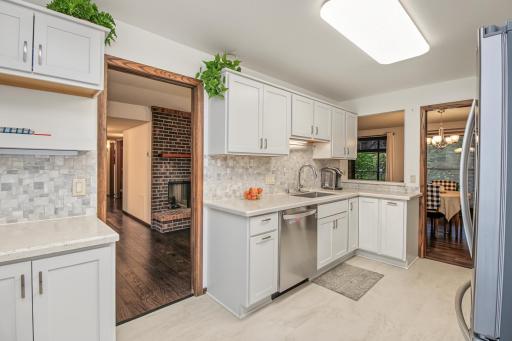 Beautifully renovated kitchen features solid surface countertops, stainless appliances and tile floor and backsplash. This kitchen will impress!