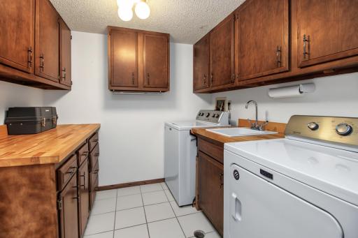 Large laundry room with abundant storage.