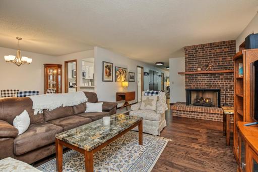 Hardwood floors and impressive gas fireplace are features in the spacious living room.