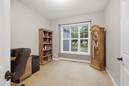 A dedicated main-level office is conveniently located just off the front entry and features a large front-facing window that fills the space with natural light while providing a pleasant neighborhood view.