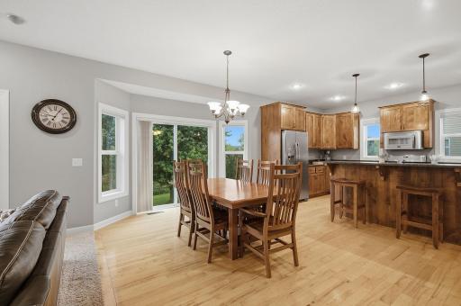 An open dining space flows seamlessly between the living room & kitchen, with hardwood flooring & plenty of room for a full-size table. A patio door brings in abundant natural light and provide backyard access, ready for the addition of a custom deck