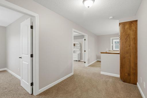 An extra-wide upper-level landing with 8-foot ceilings creates an open, spacious transition between the bedrooms, while built-in cabinetry provides convenient additional storage and makes great use of the hallway space.