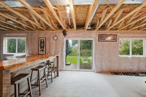 The walkout lower level offers direct access to the stamped and stained concrete patio and spacious backyard. Large windows bring in natural light.