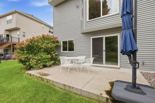 A stamped and stained concrete patio extends directly from the walkout lower level, creating a generous outdoor space for dining, grilling and entertaining with convenient access to the backyard.