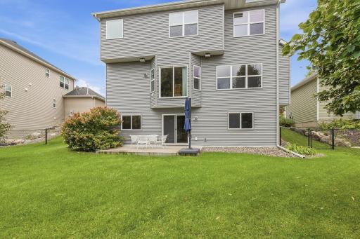Rear exterior highlights the homeâs walkout lower level and direct access to the stamped concrete patio. The spacious lawn and fully fenced yard provide plenty of room to enjoy the outdoors.