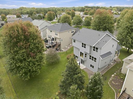 An aerial view showcases the homeâs impressive fenced backyard with mature trees, expansive lawn and walkout access to the patio. A wonderful combination of usable outdoor space and established landscaping.