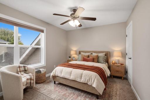 With a little separation from the other upper-level bedrooms, this spacious bedroom offers added privacy along with a walk-in closet, large window and ceiling fan. (Virtually Staged)