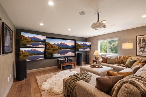 Spacious lower-level family room offers an incredible setup for movie nights, entertaining or relaxing at home. This virtually staged photo showcases the roomâs potential as a warm and inviting gathering space.