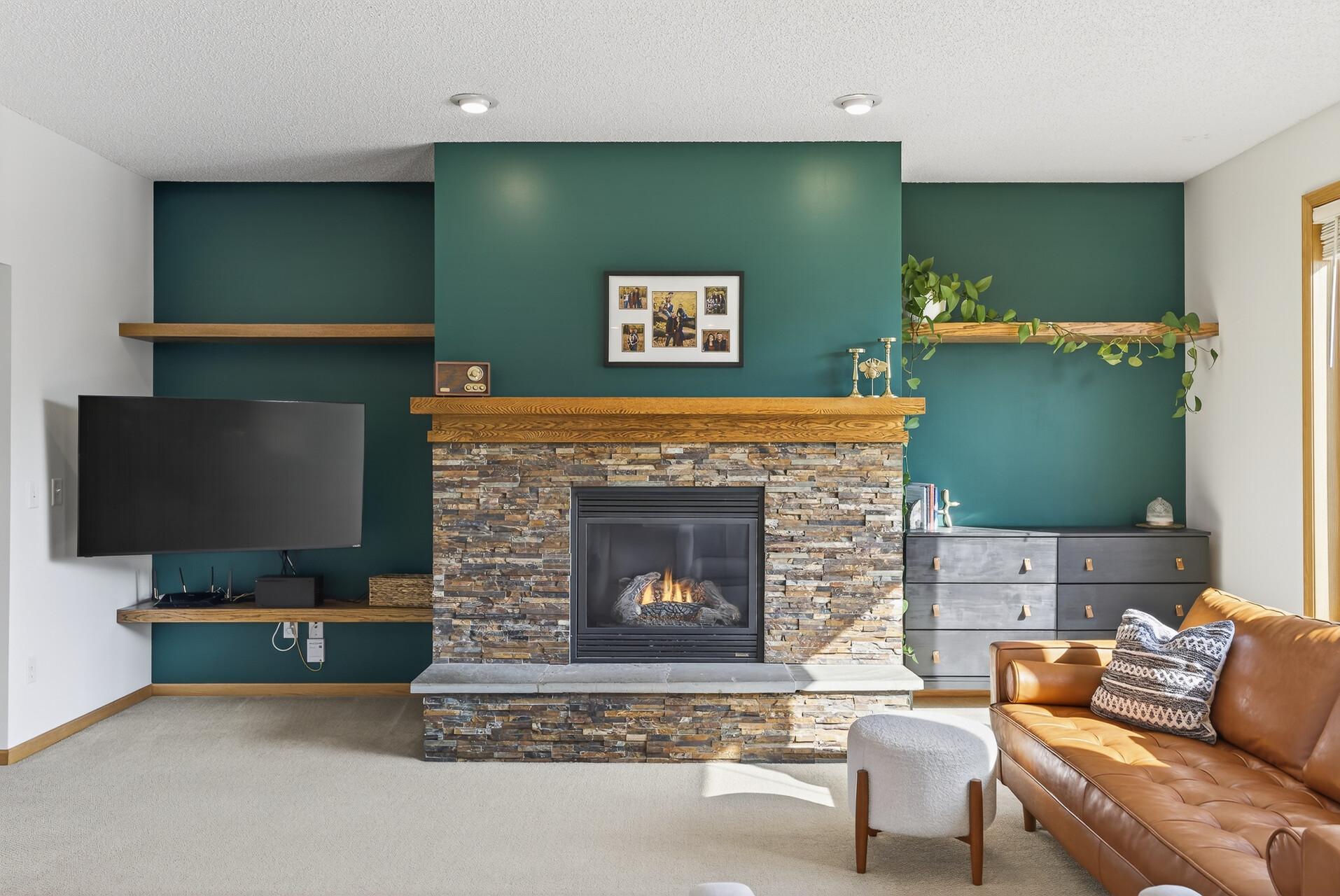 Gas Fireplace complete with stone surround, raised hearth and floating shelves.