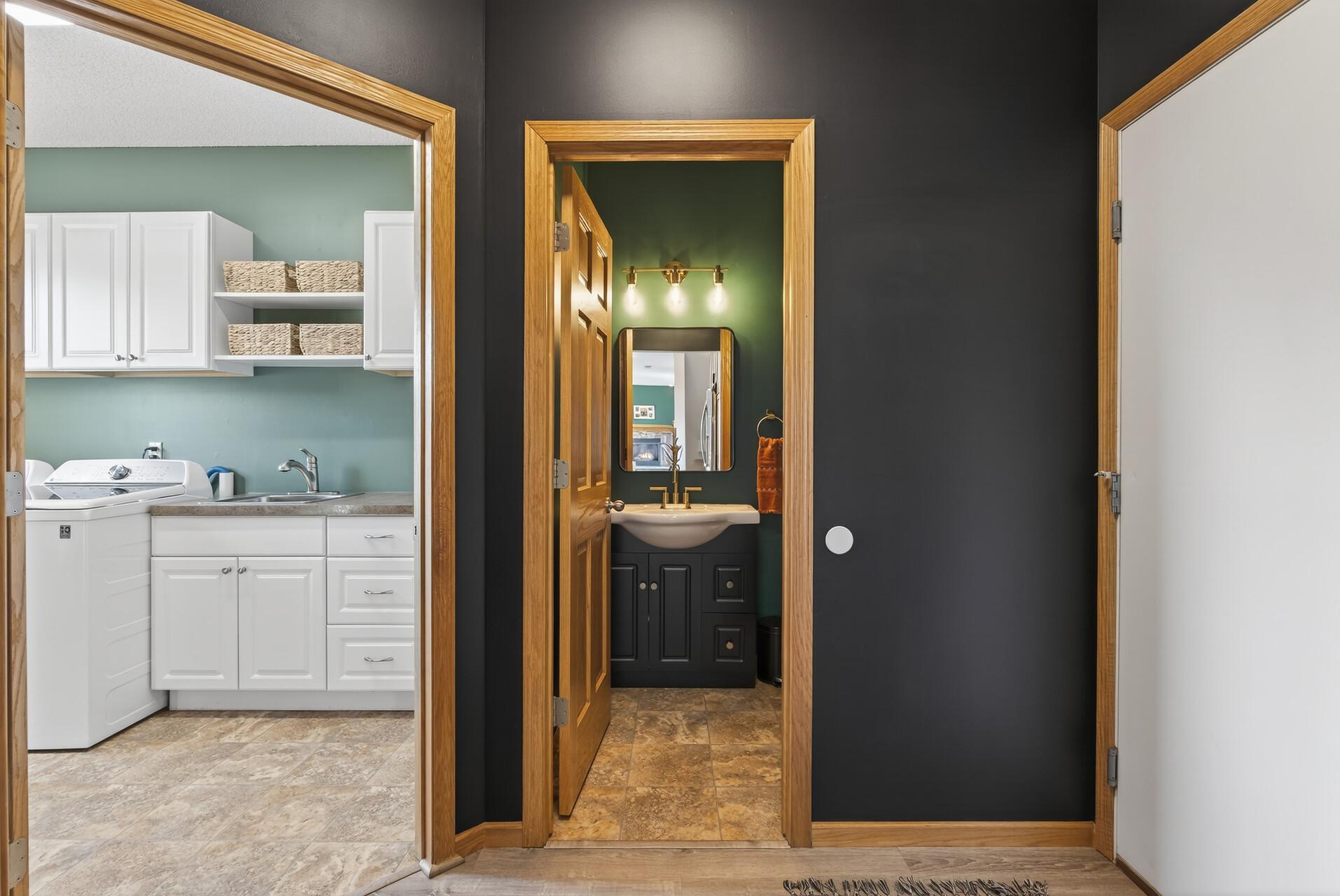 Off the Kitchen convenient Main Floor Laundry, Powder Room and Garage access.