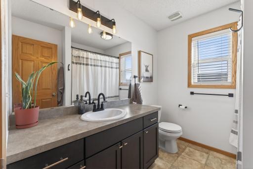Upper Level Common Bath with oversized vanity and extra storage space.