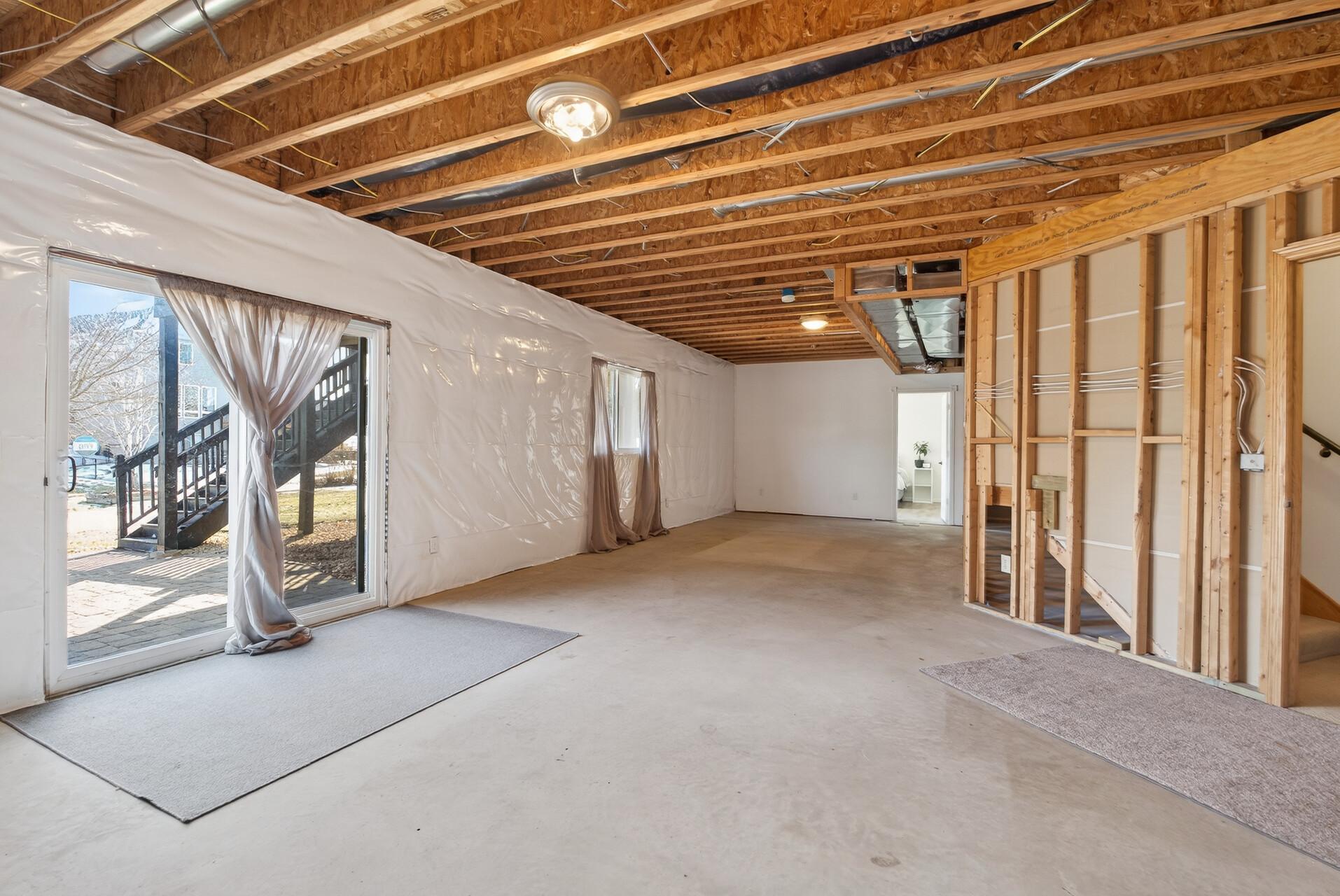 Walk out Lower Level and 3/4 bath roughed in and ready for sheetrock! Finished Bedroom #5 is at the far end.
