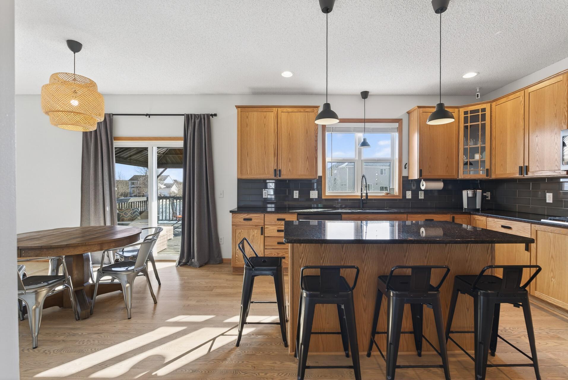 Desirable hardwood floors, custom cabinetry, large center island, granite countertops and coordinating tile backsplash.