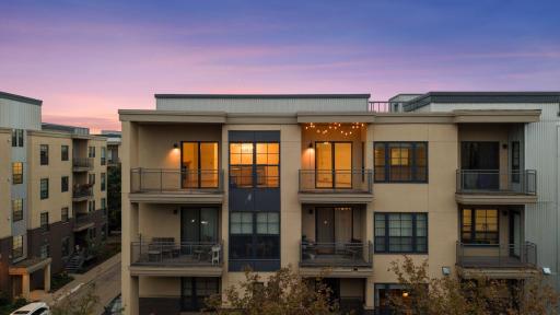 The large balcony on the left is off the living room and the second balcony with the string accent lighting is off the den.