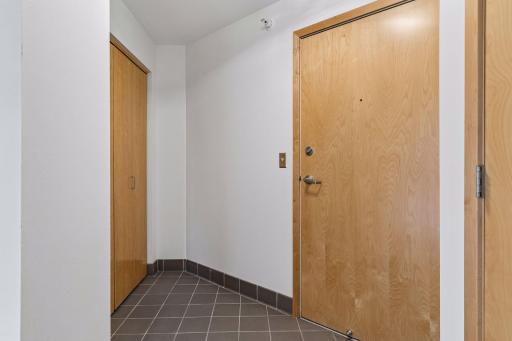 The unitâs entry foyer features practical ceramic tile flooring and a wide reach-in closet with an organizer system.
