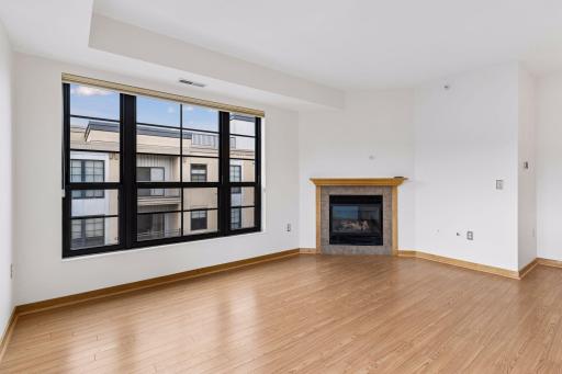 The living room features a cozy gas fireplace and large windows that fill the space with natural light.
