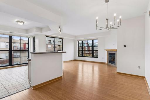 The kitchen, living room, and dining areas flow together in a spacious open-concept layout, filled with abundant natural light.