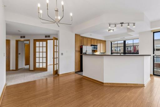 Maple woodwork and cabinetry extend throughout the unit, complemented by coordinating, durable luxury vinyl plank flooring in the main living spaces.