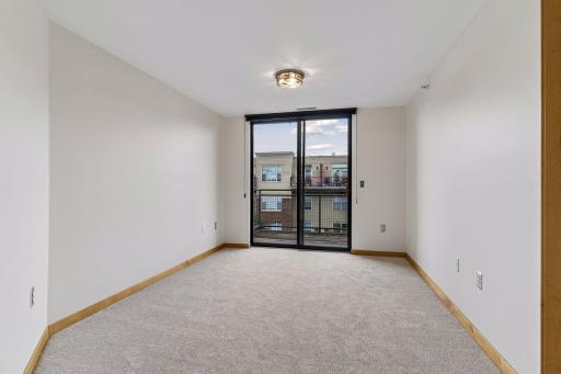 The versatile den offers space for a home office, reading nook, or additional seating area.