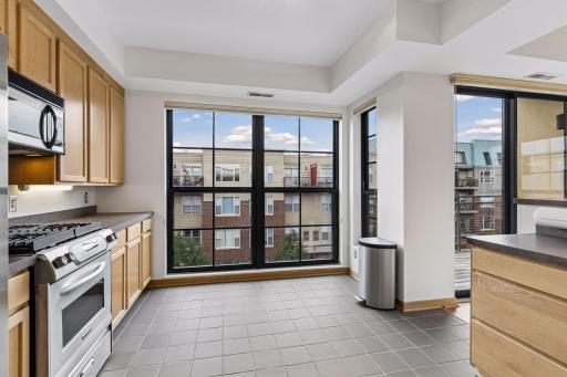 The kitchen includes space for a cafÃ© table for two beside the windowâan inviting spot for morning coffee.