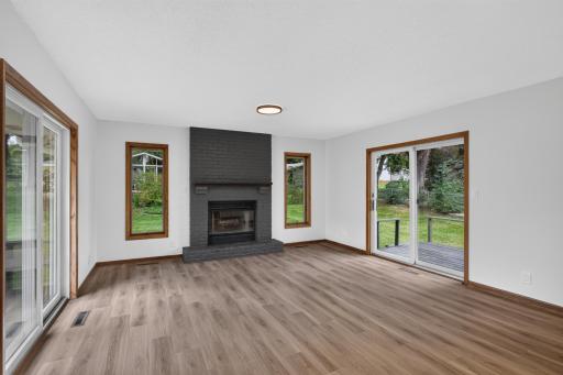 Back family room with LVP flooring and fireplace