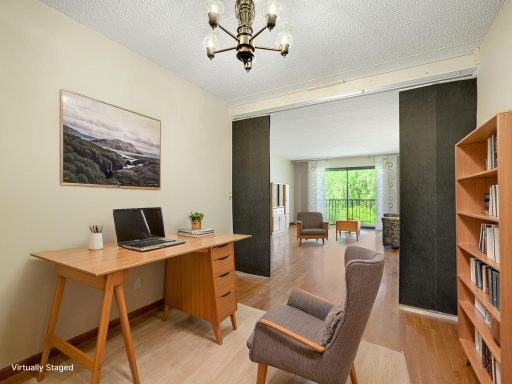 In addition to the bedroom, there is a bonus room off the living room that could be a guest space, home office, den or playroom! Virtually staged photo.