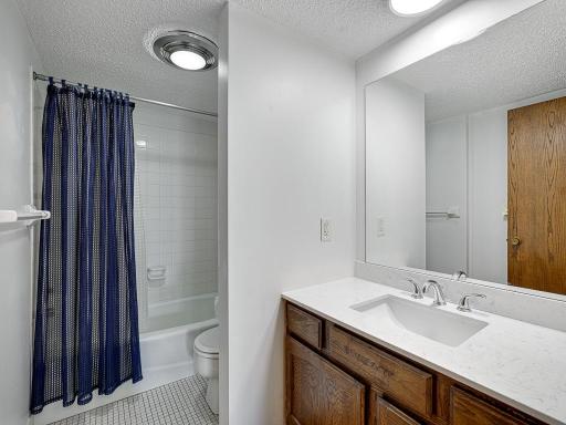 The full bathroom has a new countertop & cool lighting.