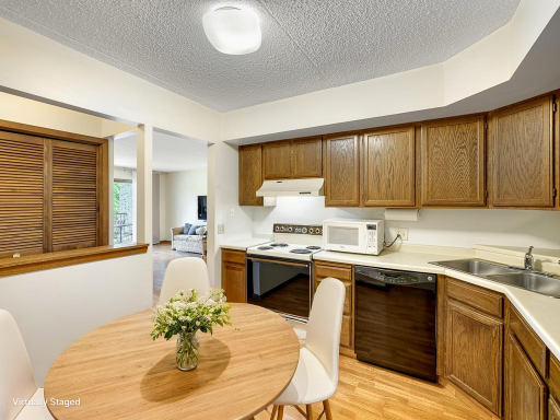 The eat-in kitchen comes with all appliances. Virtually staged photo.