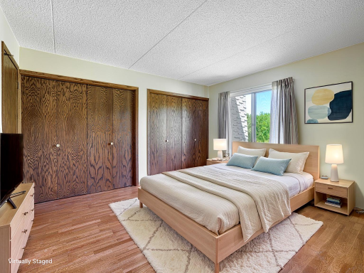 The bedroom has a full wall of closets! Virtually staged photo.