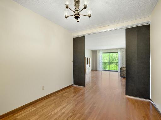 This bonus room has a sleek room divider than can be closed for more privacy.