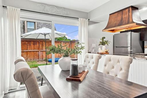 An inviting dining area with direct access to the fenced outdoor space.