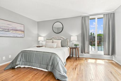 A spacious upper-level bedroom with hardwood floors and plenty of room to unwind.
