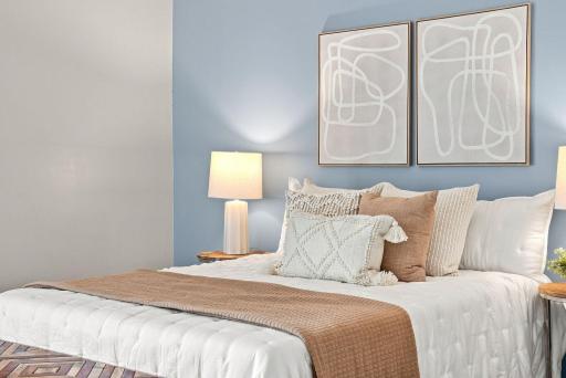 Thoughtful styling highlights the warmth and versatility of the upper-level bedrooms.