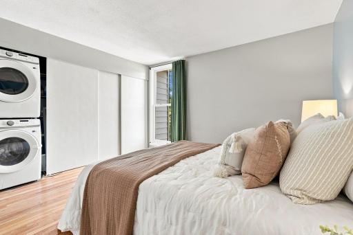 A calm, inviting bedroom with hardwood flooring and updated finishes.