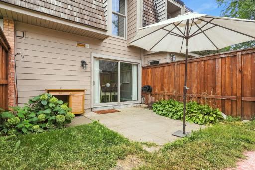 The patio and turf area offer space to dine, relax, garden, or spend time outside.