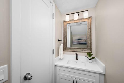 Tastefully updated main-level powder room with stylish finishes and a fresh, polished feel.