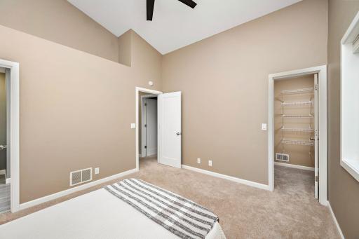 Spacious primary bedroom with vaulted ceiling, generous walk-in closet ,and convenient access to the beautifully updated full bath—thoughtfully designed for comfort and convenience.