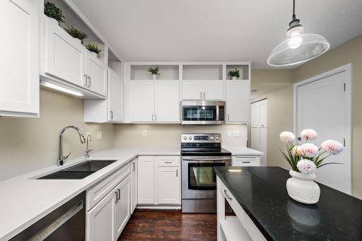 Beautiful quartz countertops, stylish backsplash and premium sink create a clean, polished look with both beauty and functionality.