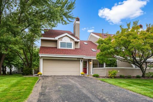 A special end-unit setting with TWO private brick-paver patios and generous green space surrounded by mature trees.