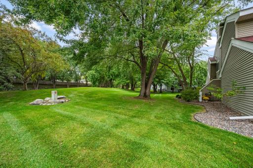 A special end-unit setting surrounded by trees and green space, offering extra privacy and a peaceful place to call home.