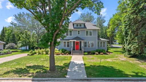 A peek of the front of the home with a bold front door to entice your attention
