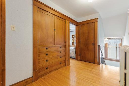 Central hallway of 2nd floor offers built-in cabinet & drawers