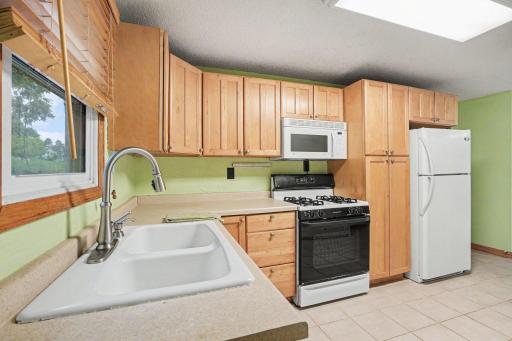 Open kitchen with a gas stove, and built-in microwave!